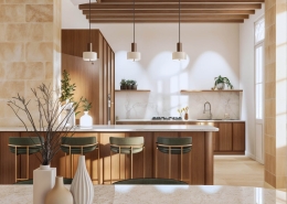 Cuisine sur mesure avec îlot central, poutres apparentes et murs en pierre dans une maison rénovée à Izon en Gironde par un architecte d’intérieur